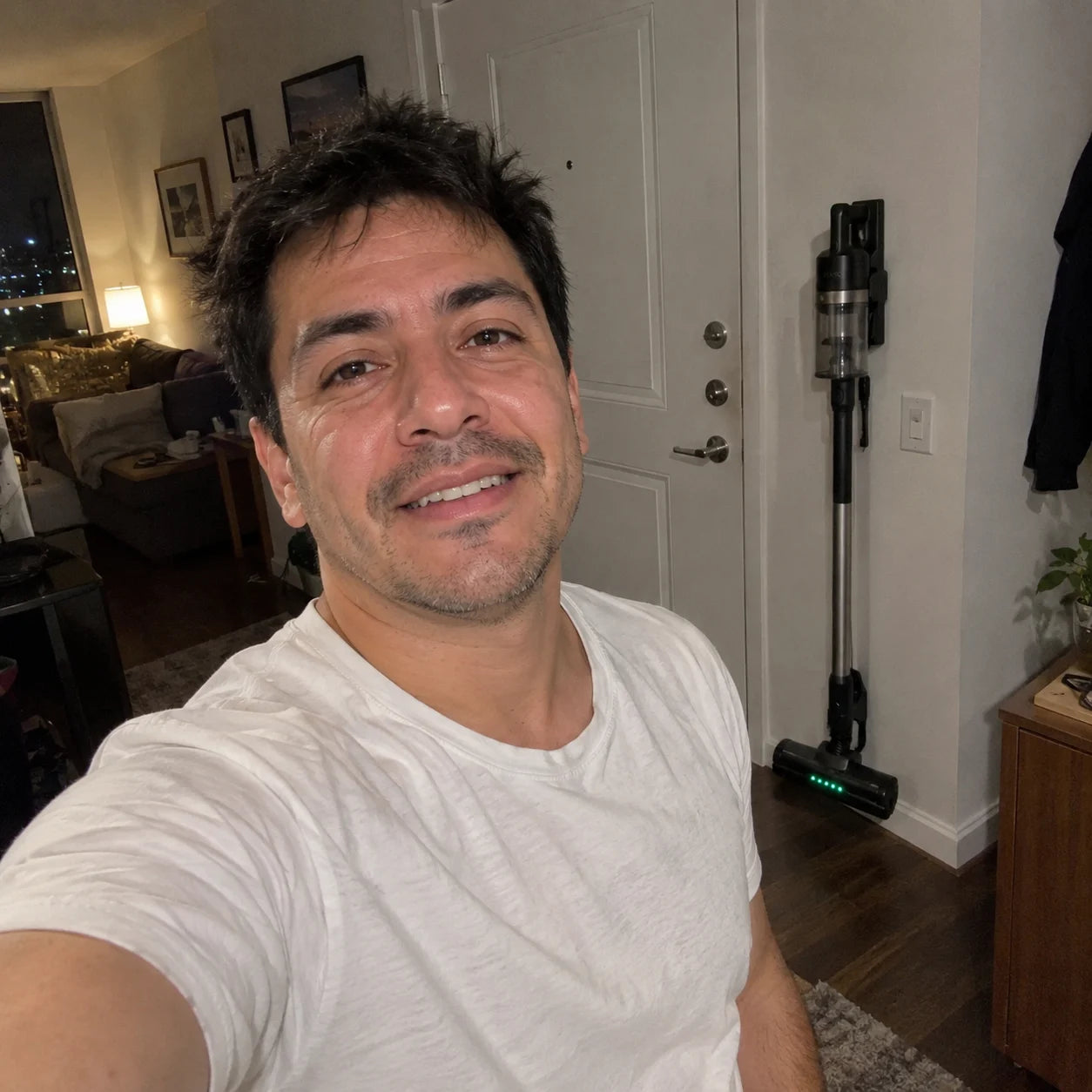 Luis in his apartment at night with the Vekto Stick on its dock by the door
