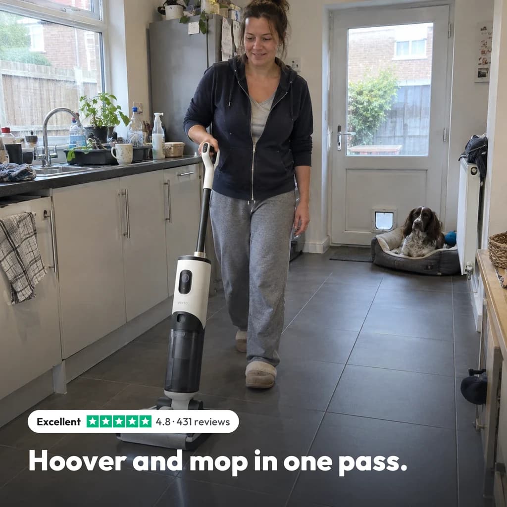 Hoover and mop in one pass: a woman guiding the Vekto Floor Washer F40 across grey kitchen tiles, her dog watching, rated 4.8 from 431 reviews