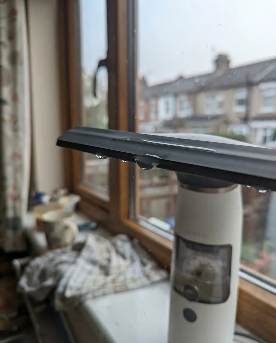 The Vekto Window Vac W10 drawing down a glass shower screen in a tiled bathroom