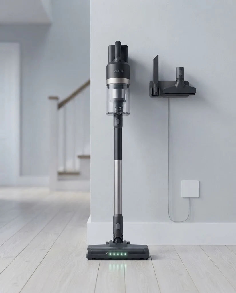 Vekto Stick standing upright on its own in a bright hallway beside its wall dock with the tools hanging on it