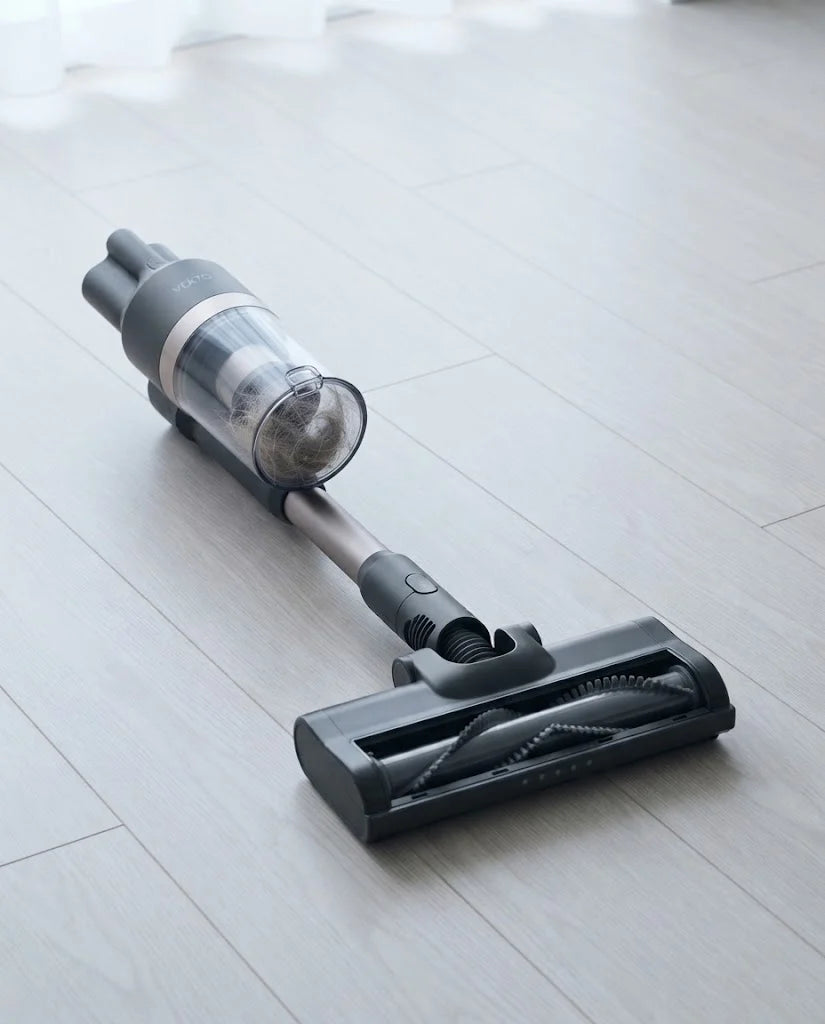 The underside of the Vekto Stick floor head with a clean V-shaped brush roll, the hair collected in the clear cup above